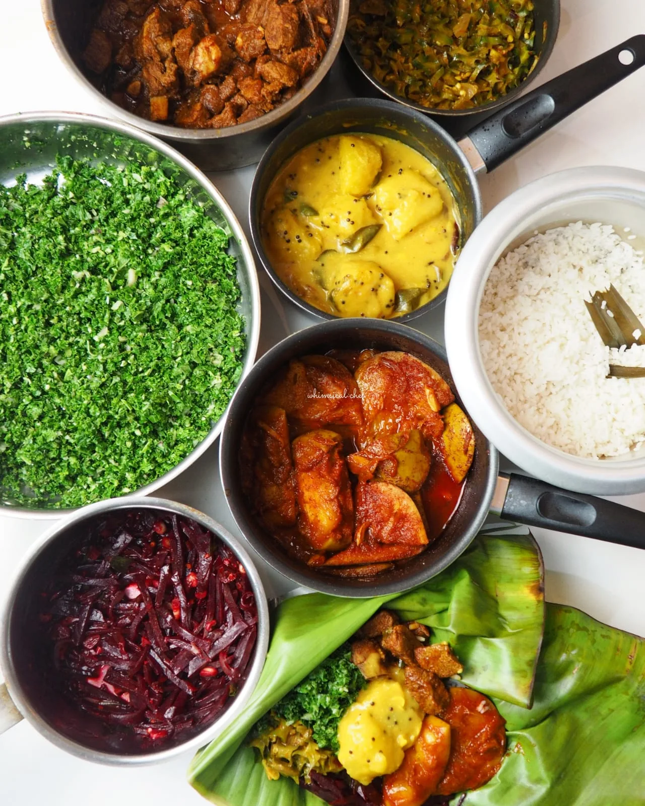 Overhead view of rice surrounded by Sri Lankan curries and accompaniments