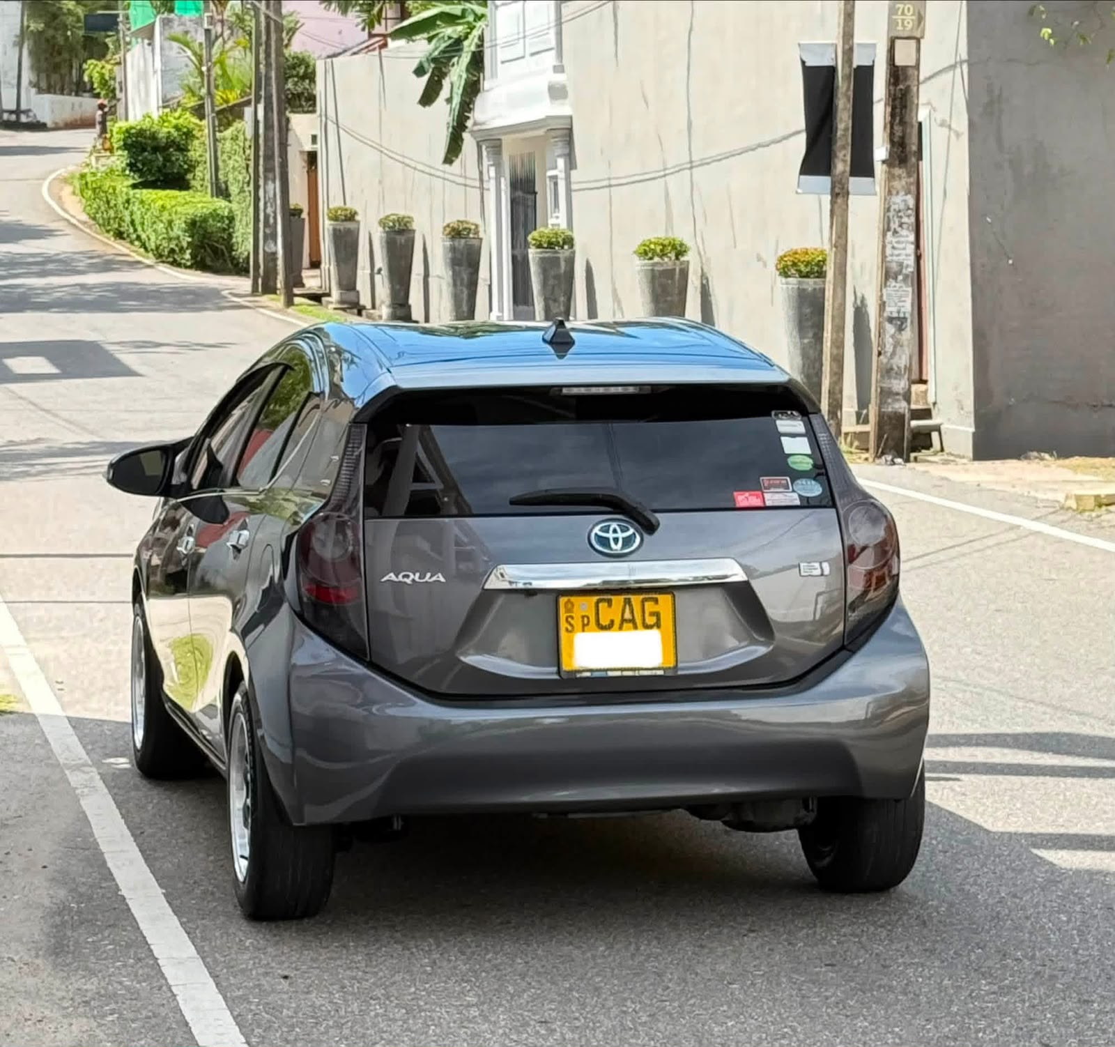 Grey Toyota Aqua viewed from the rear