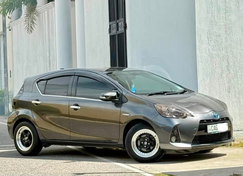 Grey Toyota Aqua viewed from the side