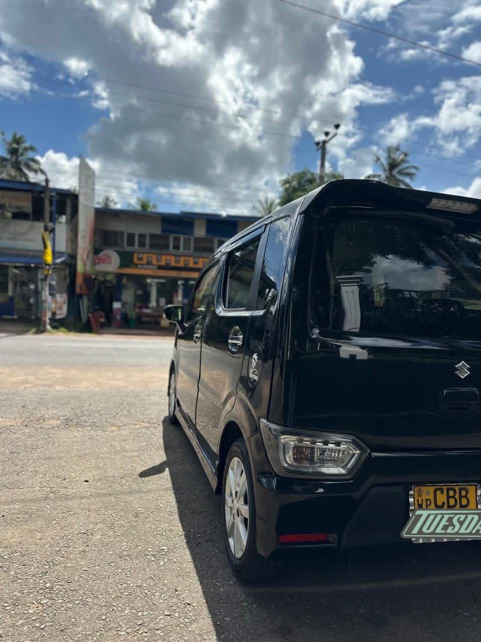 Black compact passenger vehicle viewed from the rear