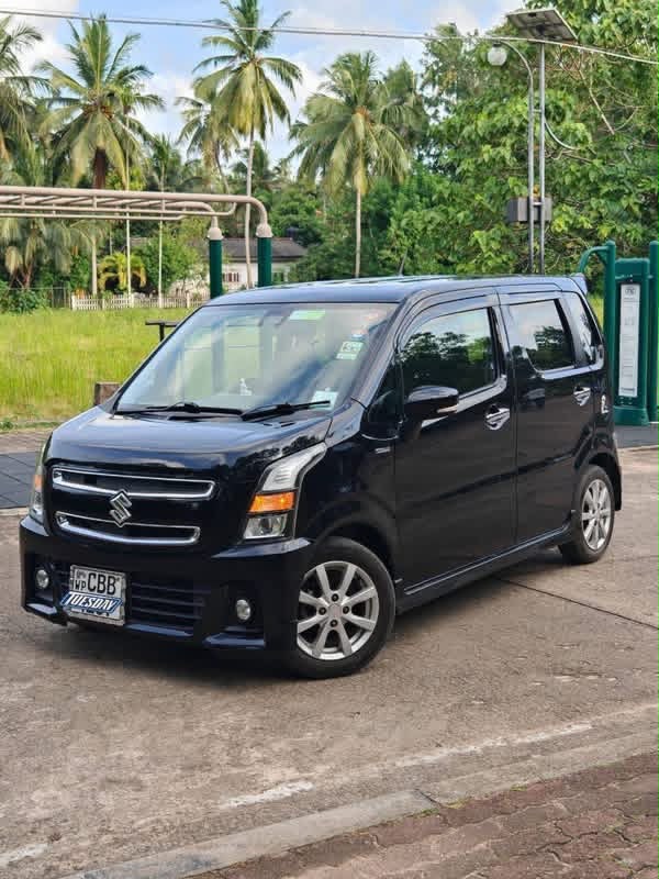 Black compact passenger vehicle viewed from the side