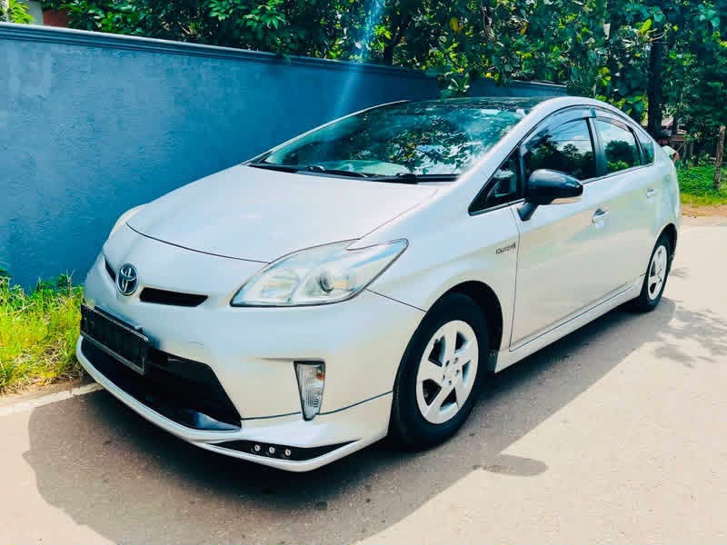 White Toyota Prius viewed from the front and side