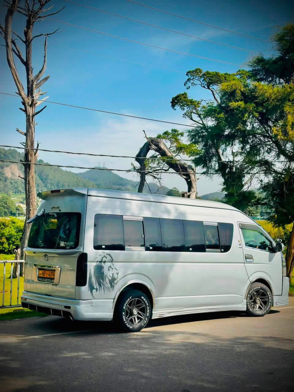 Silver passenger van viewed from the side